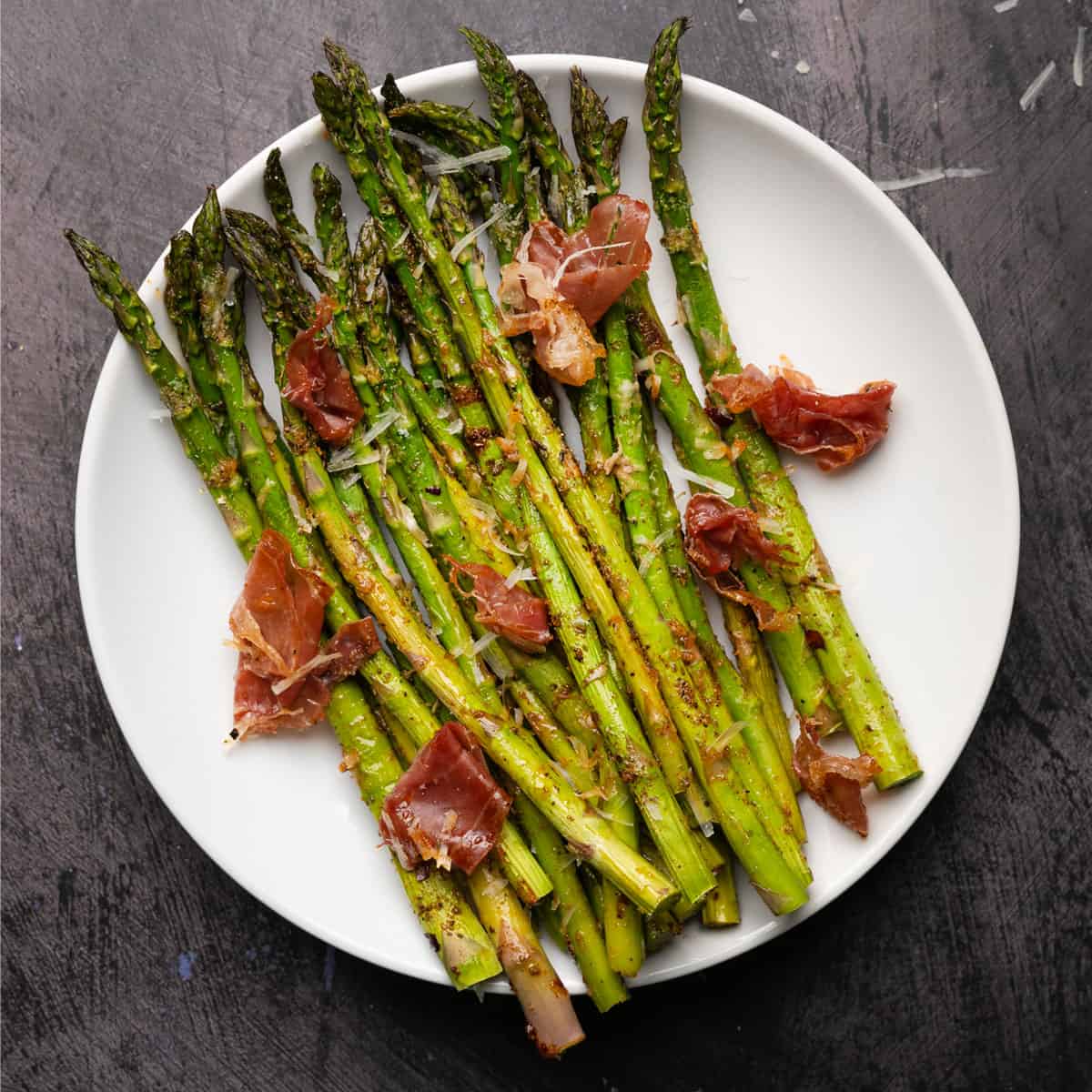 a serving plate of roasted asparagus with parmesan