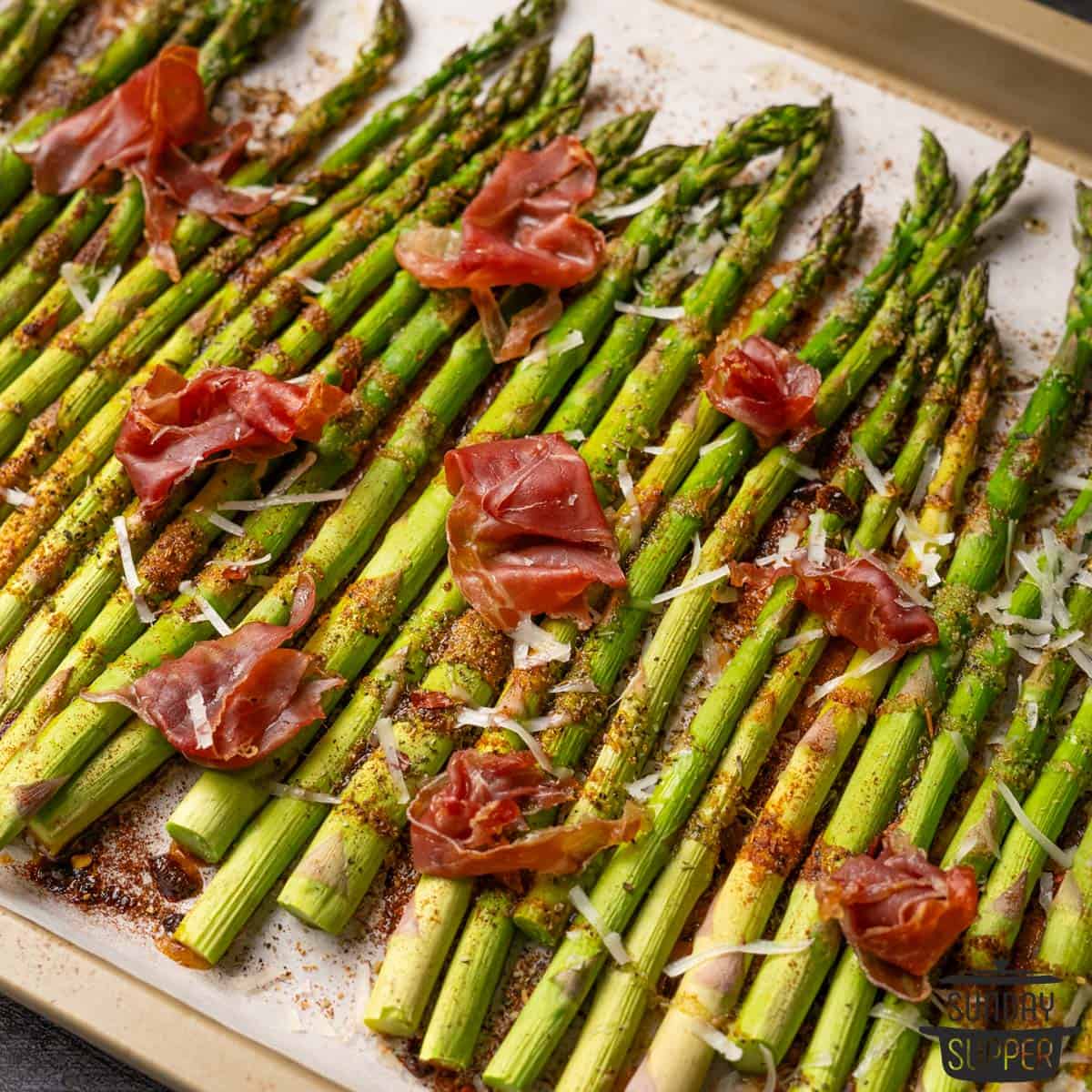 the roasted asparagus on a baking dish with parmesan