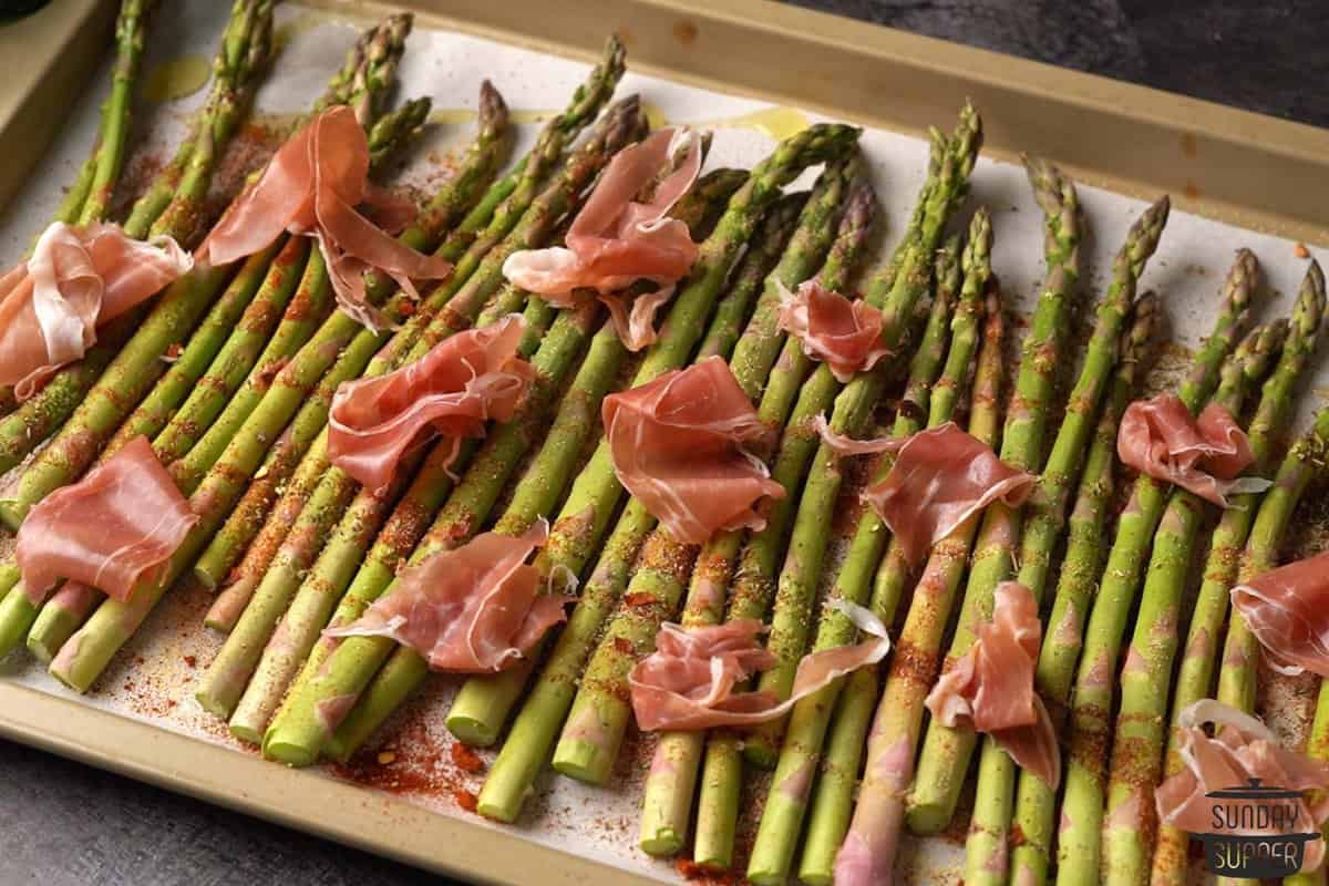 torn prosciutto added to the top of the asparagus