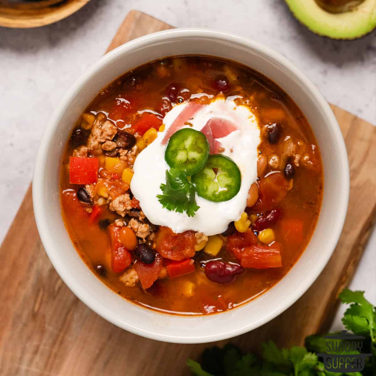 a bowl of chili with toppings