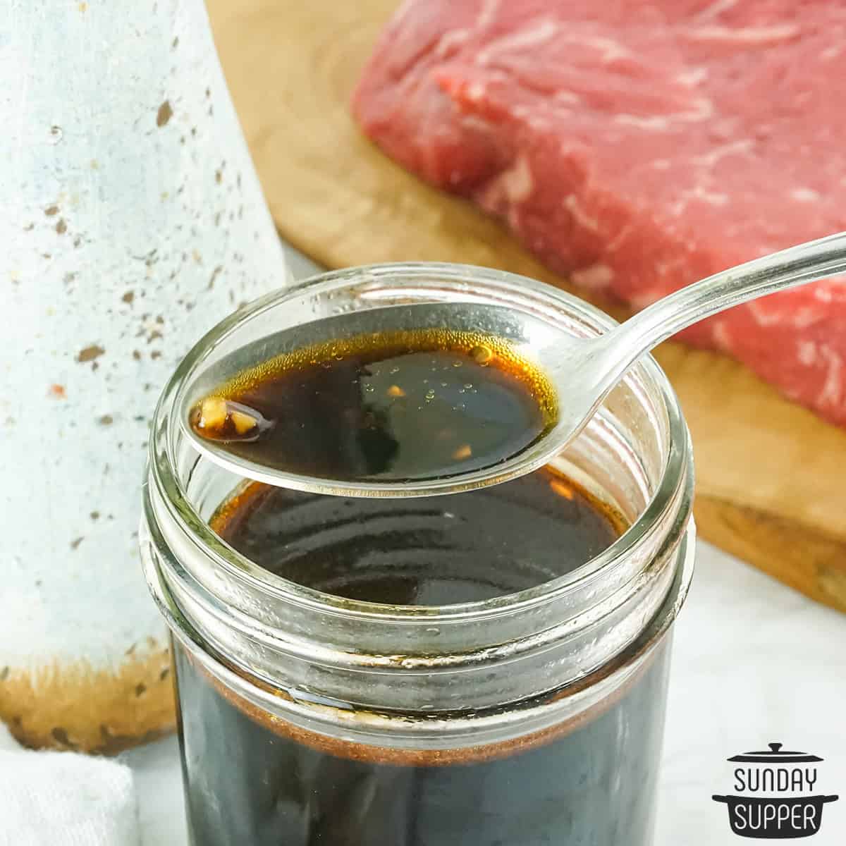 asian steak marinade in a jar with a spoon