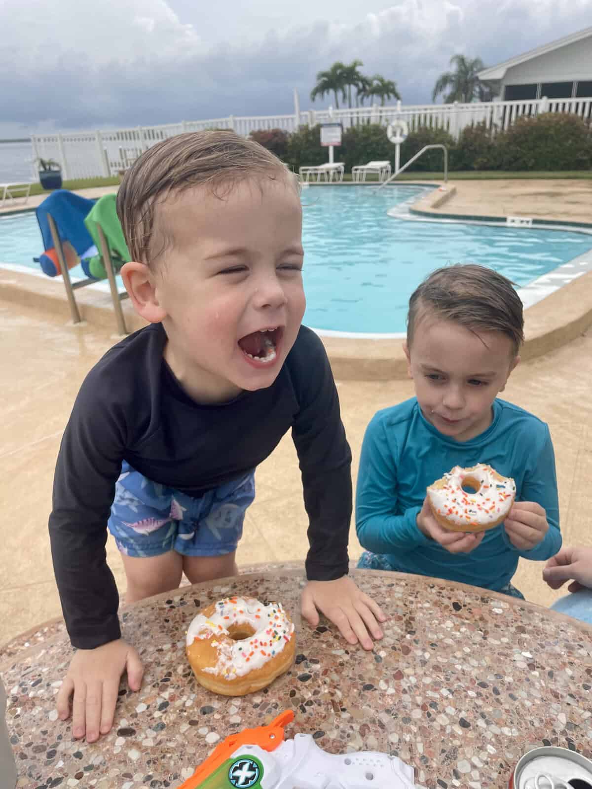 rory and aiden at the pool with donuts