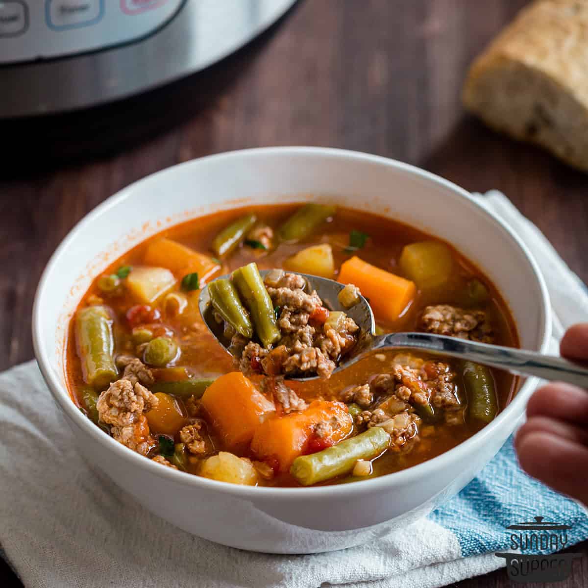 a spoon with hamburger soup