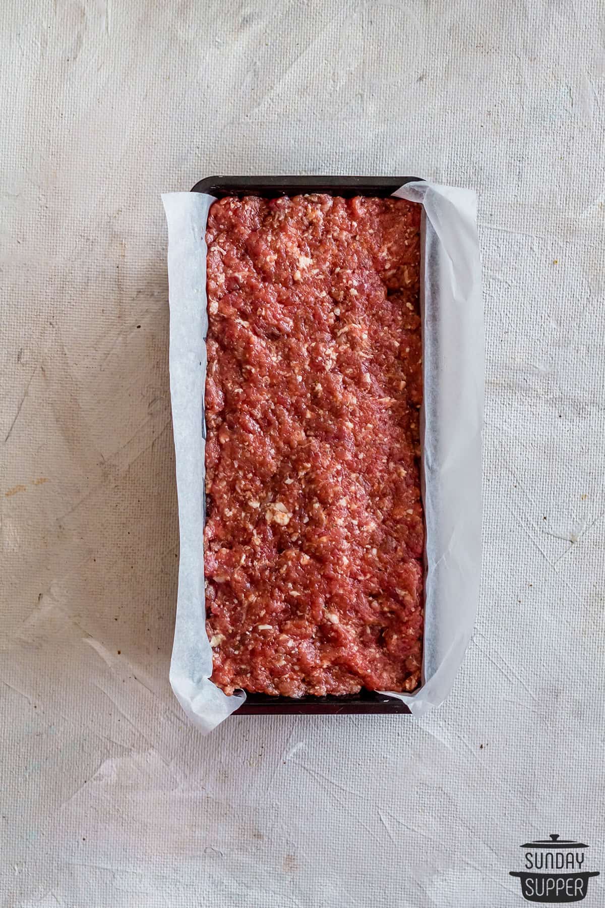 meatloaf pressed into baking pan