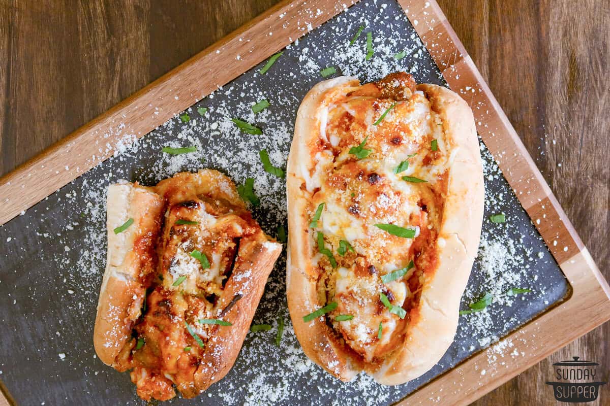 a meatball sub and a half on a serving board