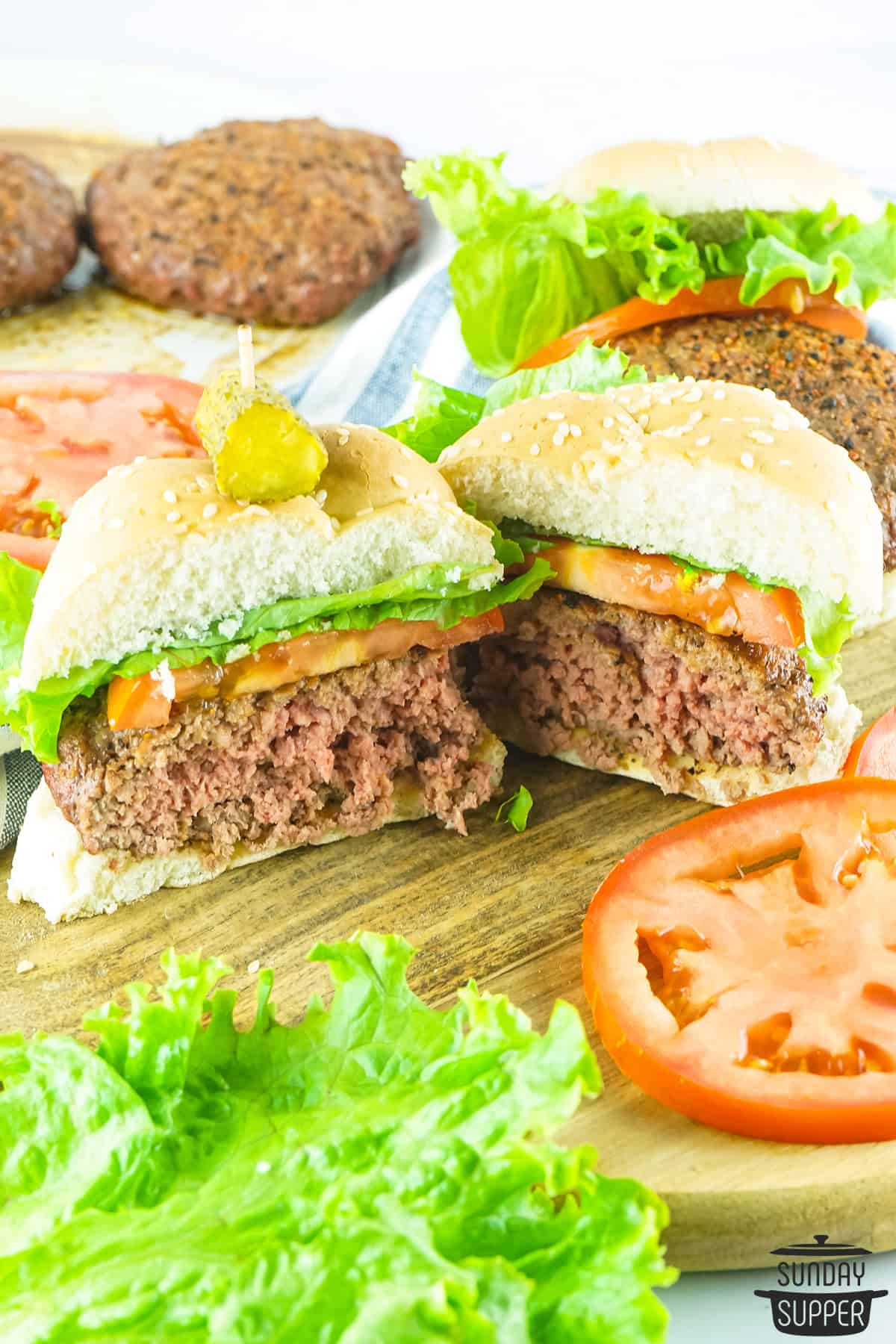 two halves of a smoked burger on a serving board