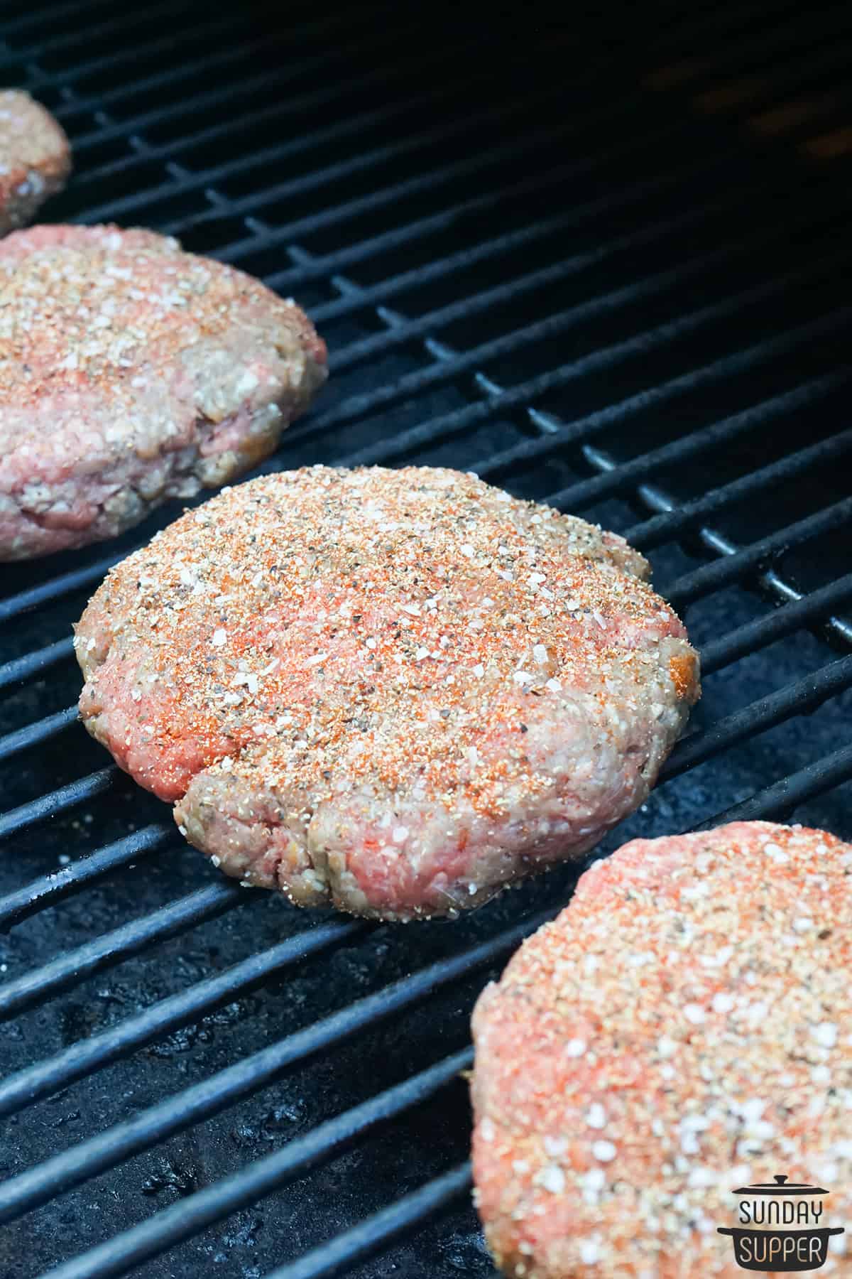 burgers cooking on smoker