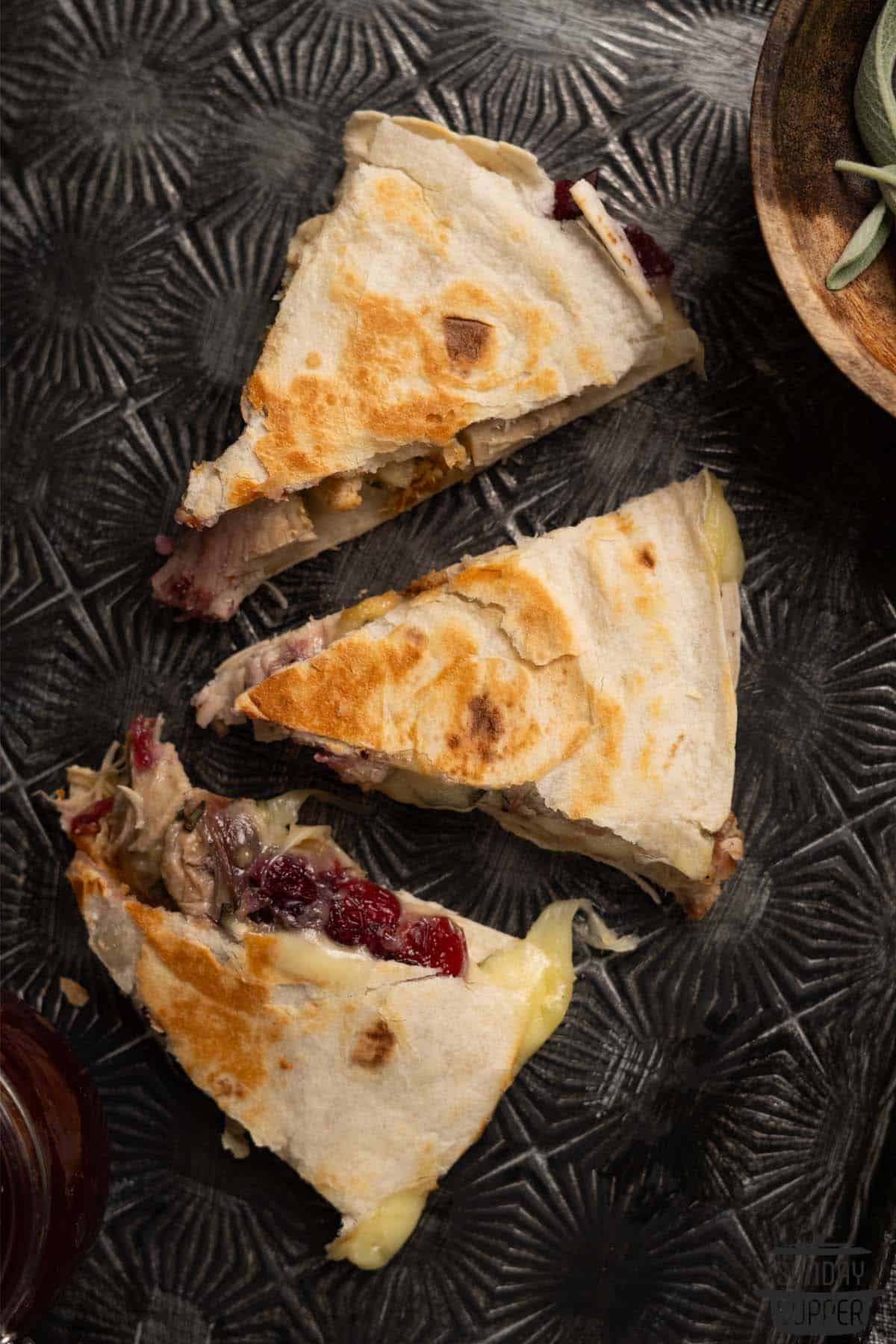 three slices of turkey quesadilla to show the gooey inside