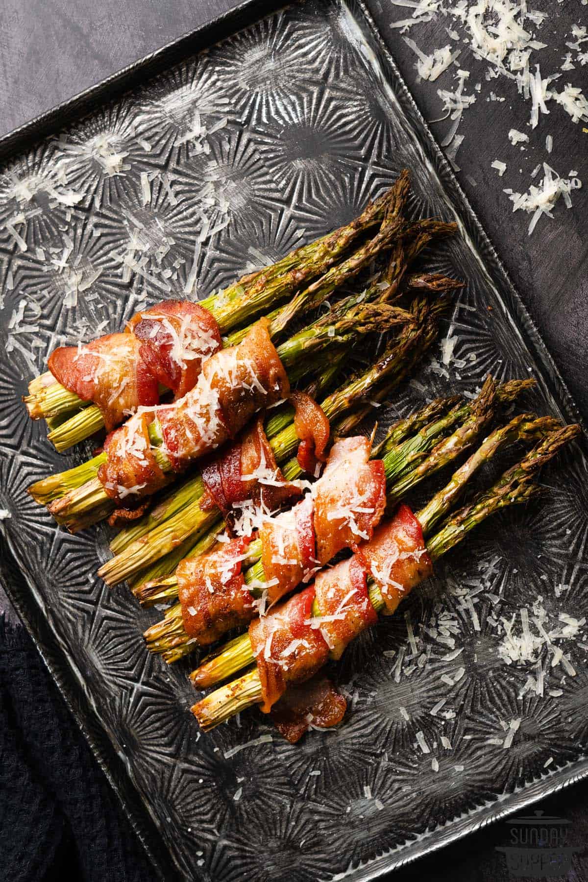 air fried bacon wrapped asparagus on a tray