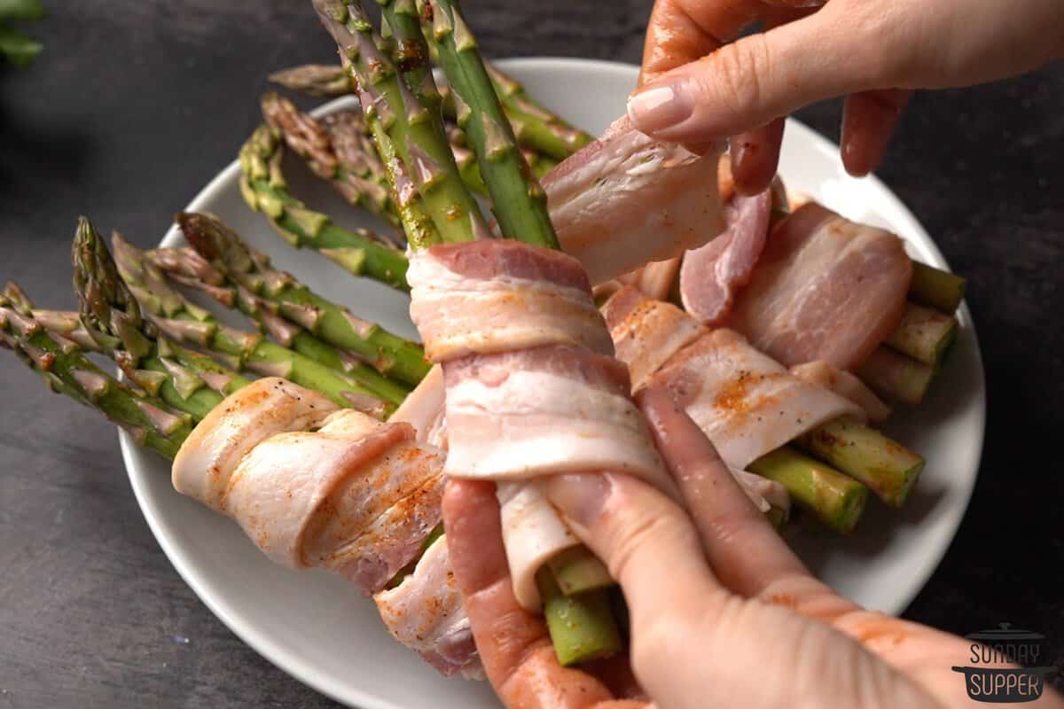 wrapping bundles of asparagus with bacon