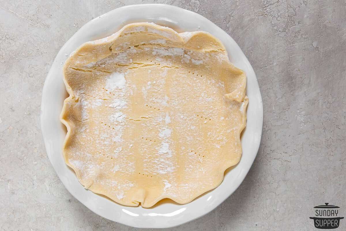 a pie crust unrolled into a pie tin