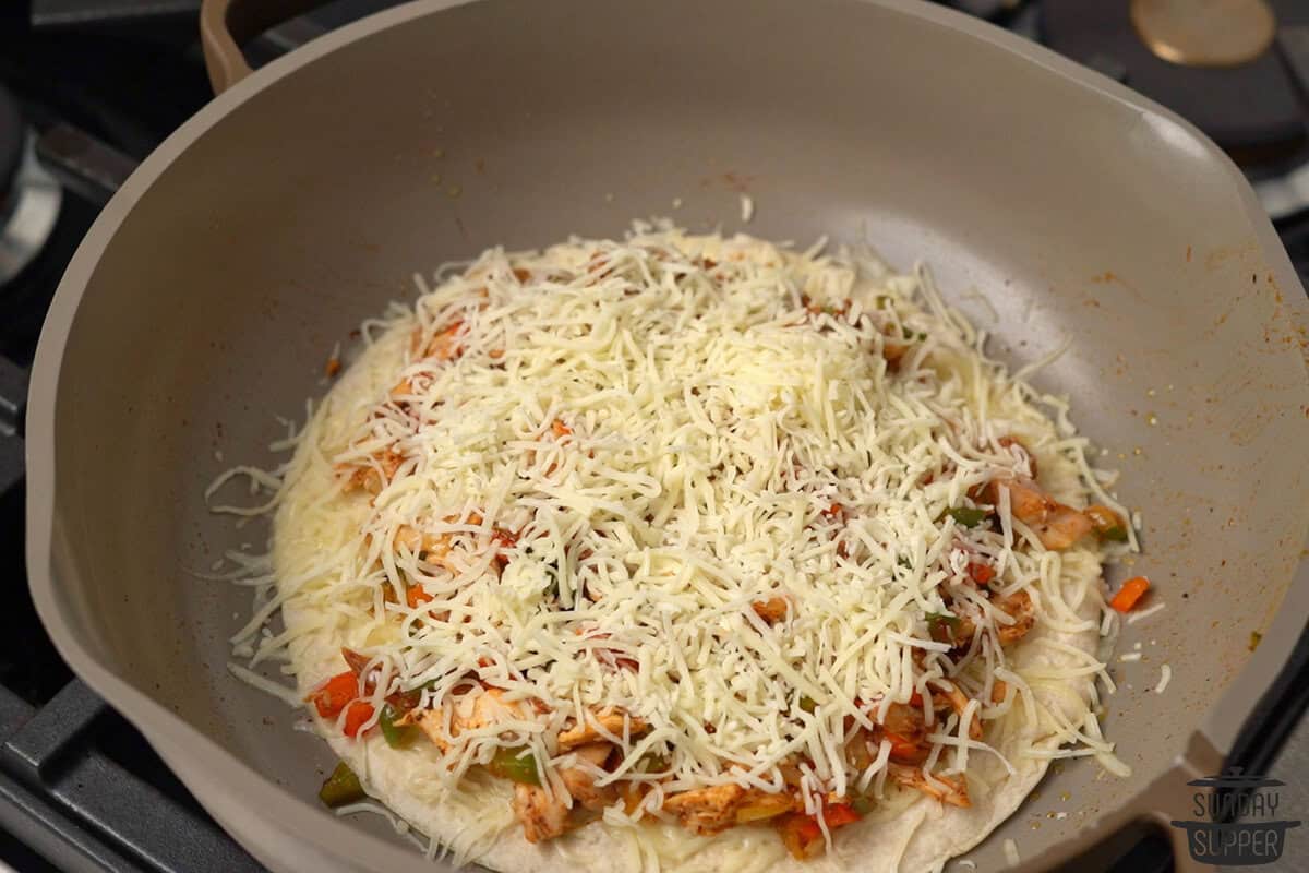 toppings added to the tortilla in the pan