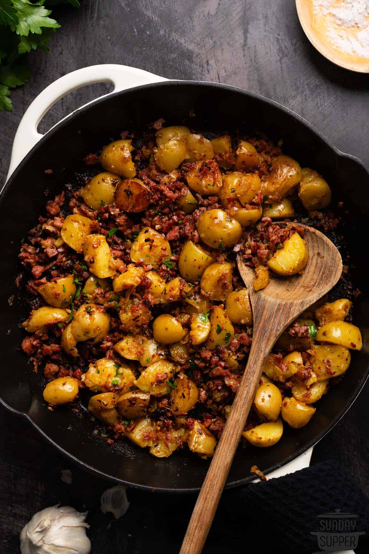 corned beef hash with a wooden serving spoon