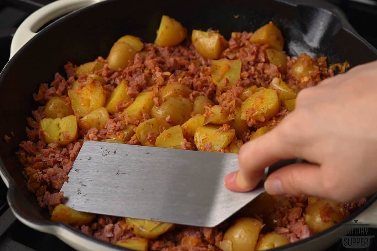 pressing the hash down with a spatula