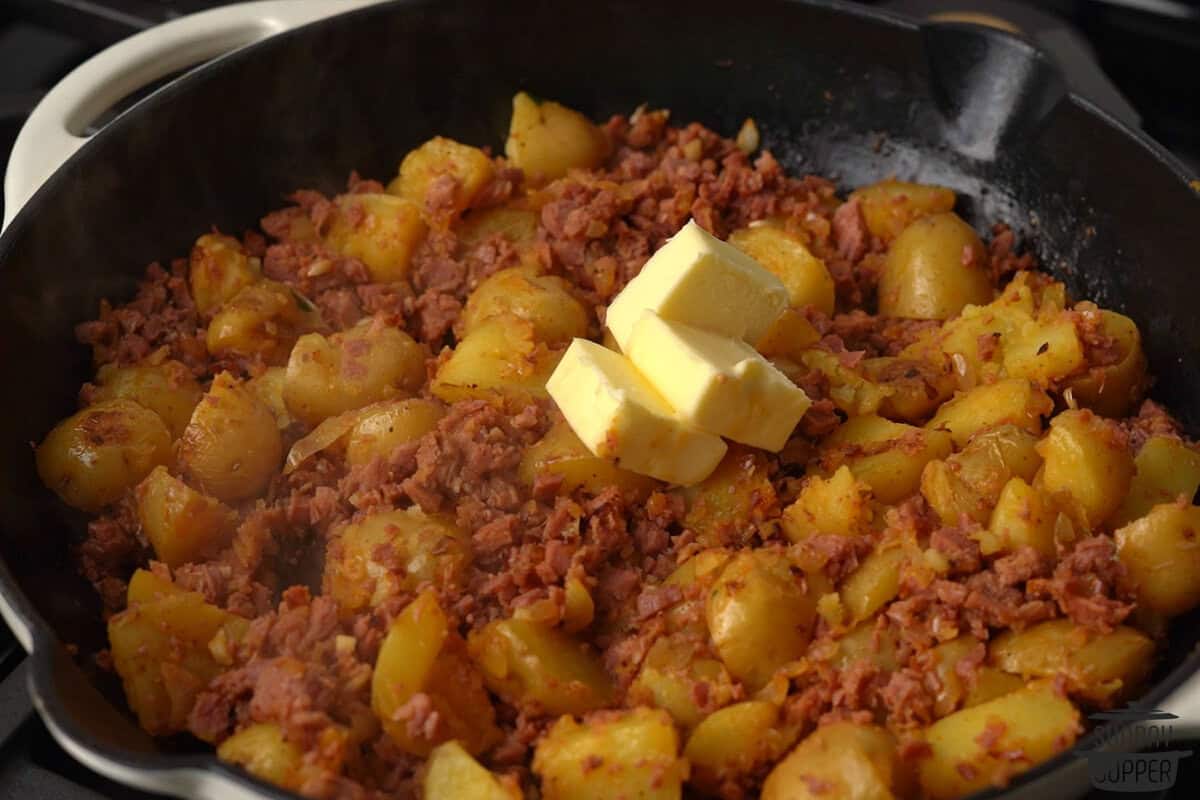 the rest of the butter added to the pan with the hash