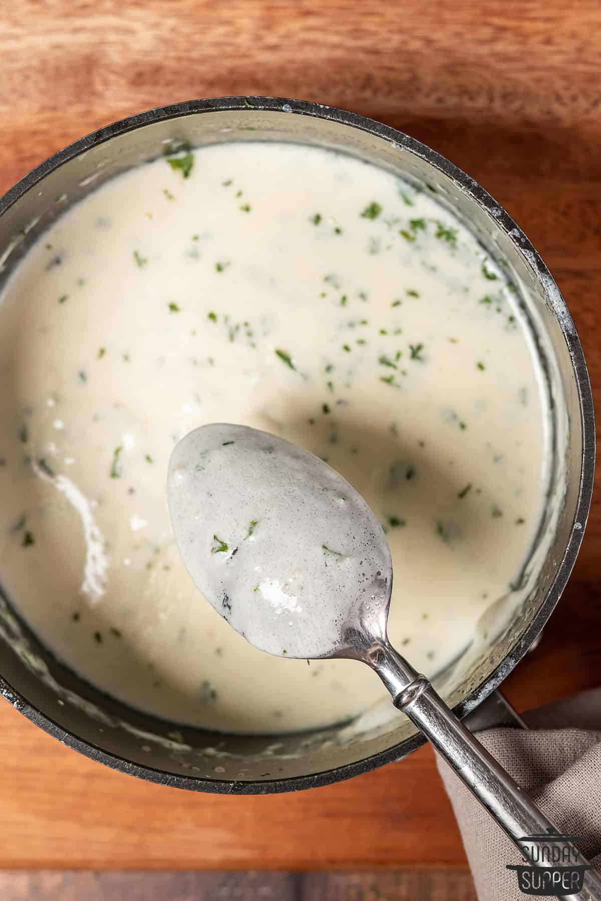 garlic sauce in a bowl with a spoon