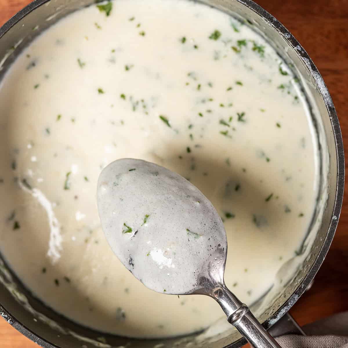 garlic sauce in a bowl with a spoon