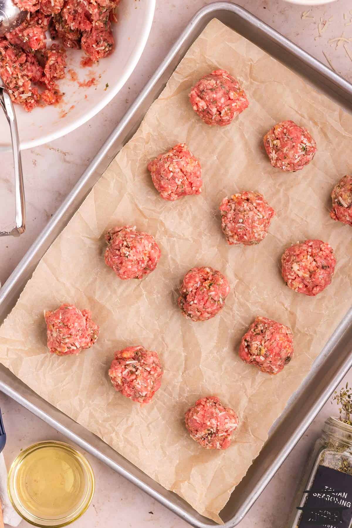 meatballs rolled out on a baking sheet