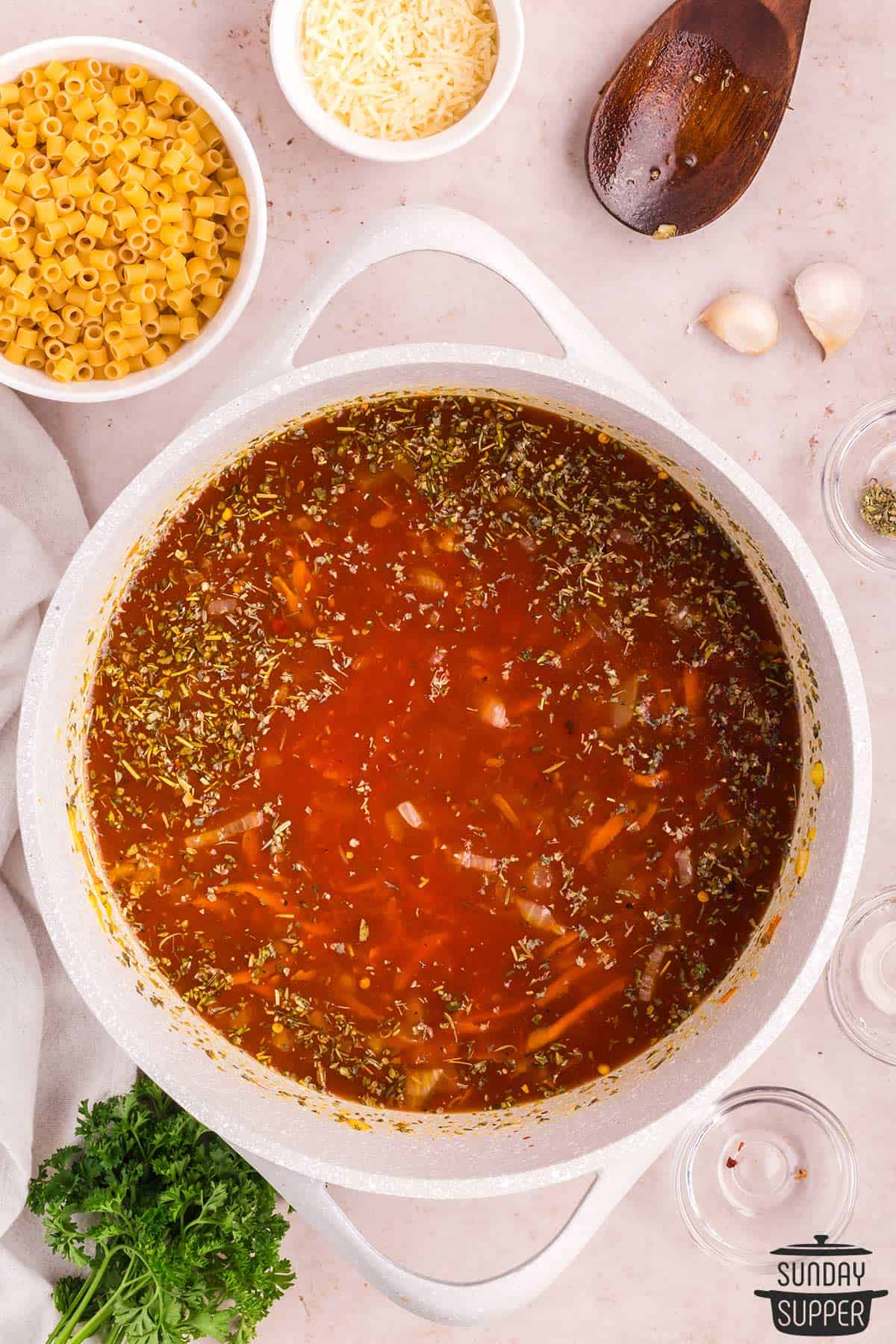 the broth and seasonings added to the pot