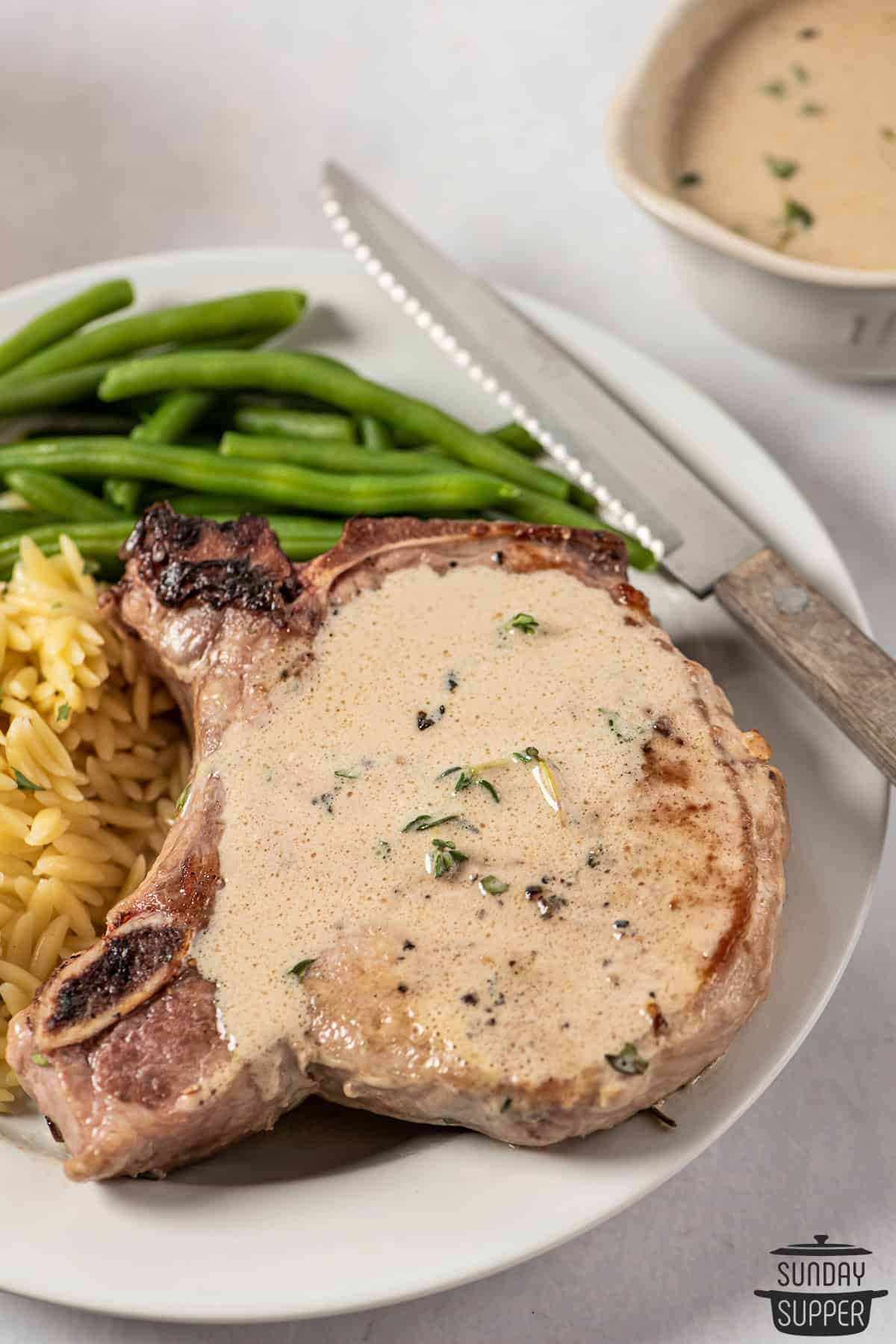 pork chops with mustard sauce on a plate