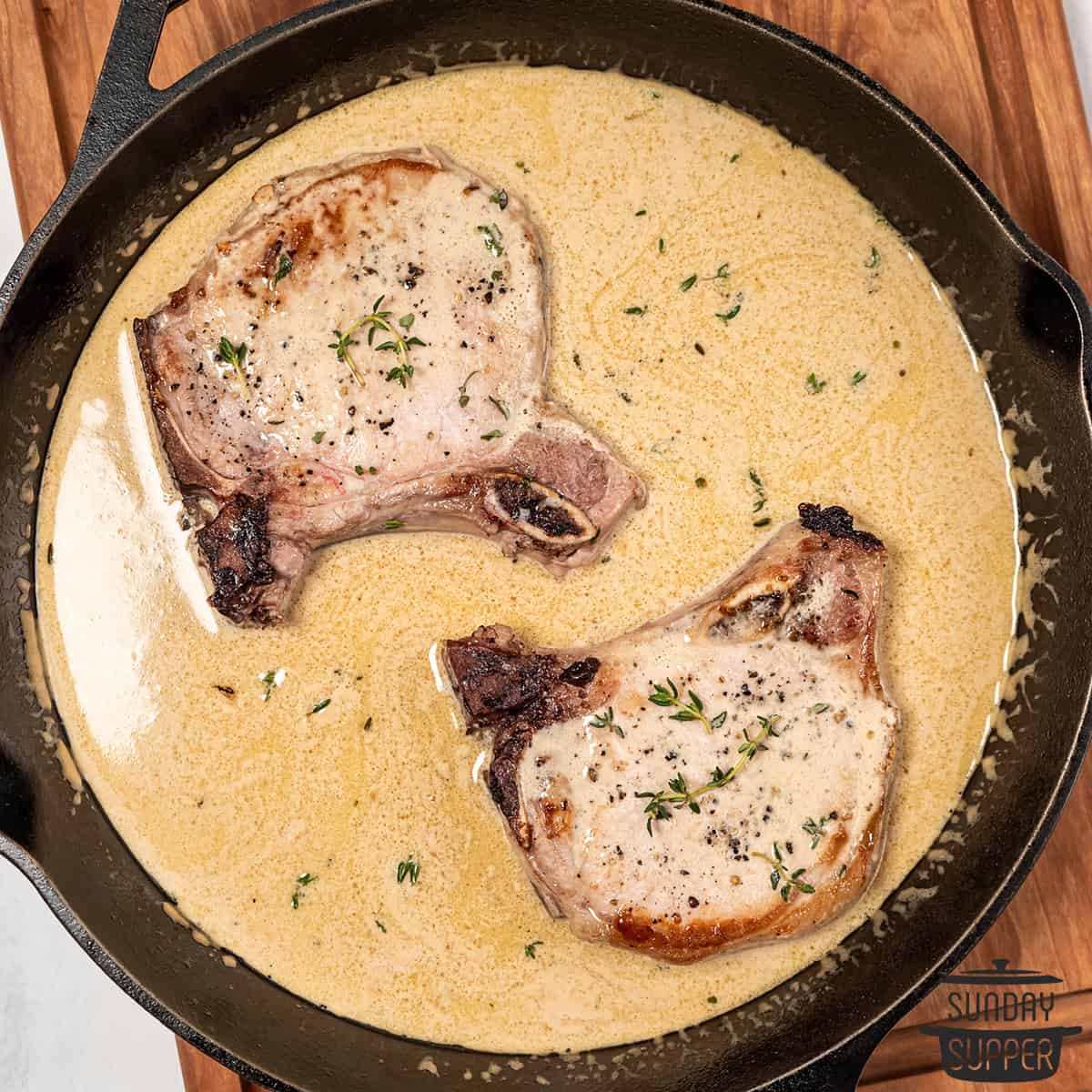 mustard sauce and pork chops in a pan