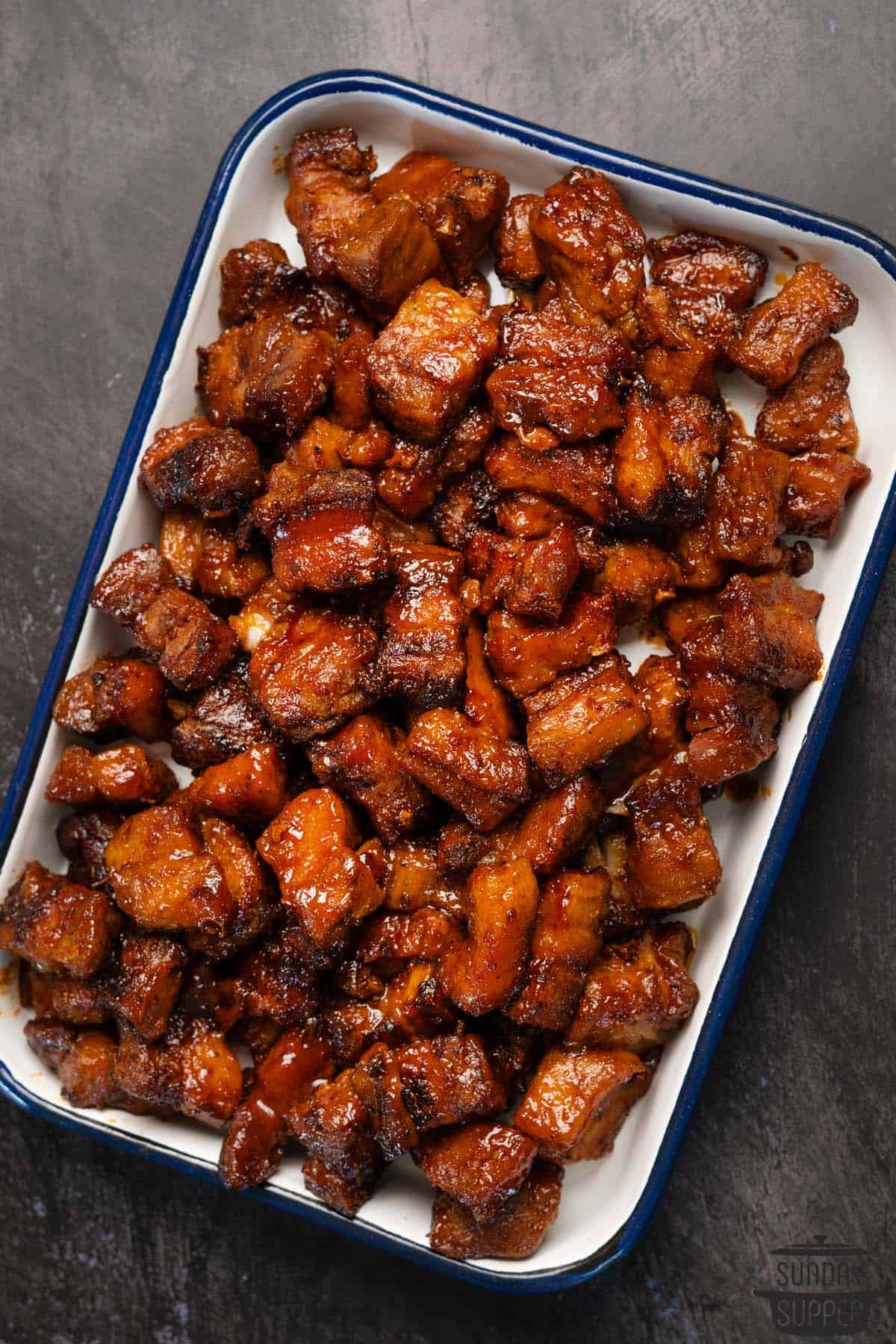 pork belly burnt ends on a baking sheet out of the oven