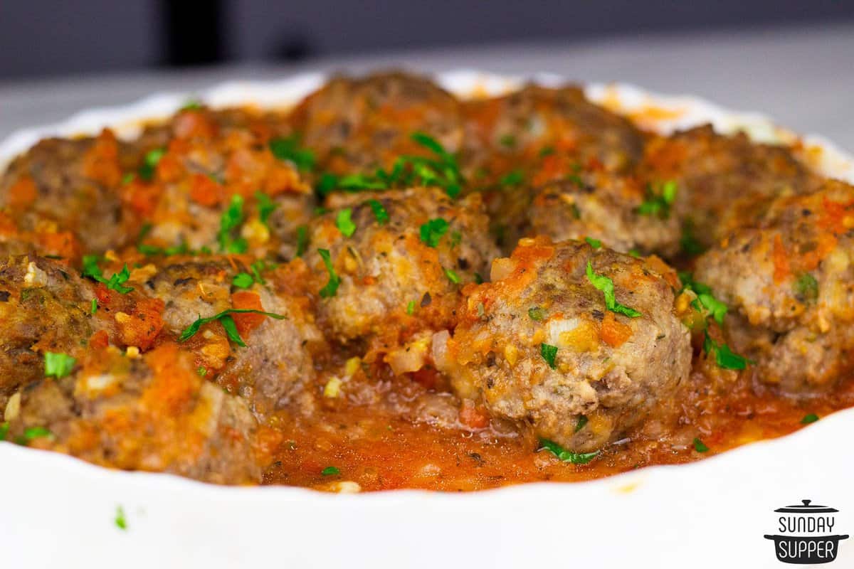 a serving platter of meatballs in tomato sauce