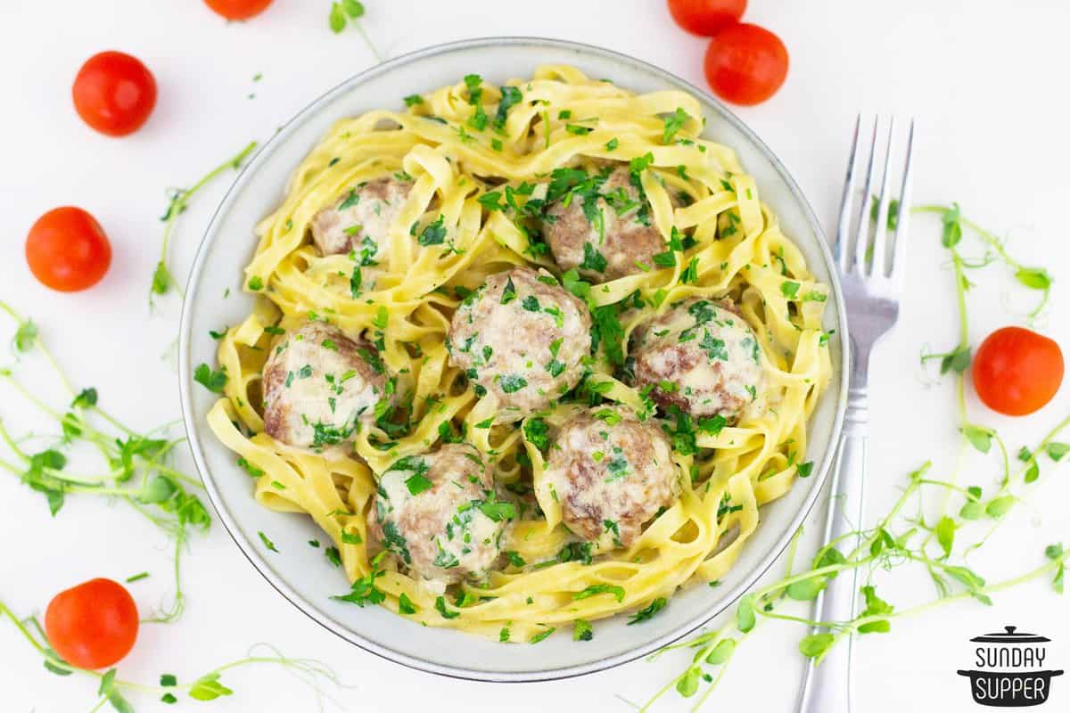 A big dinner bowl of egg noodles with swedish meatballs