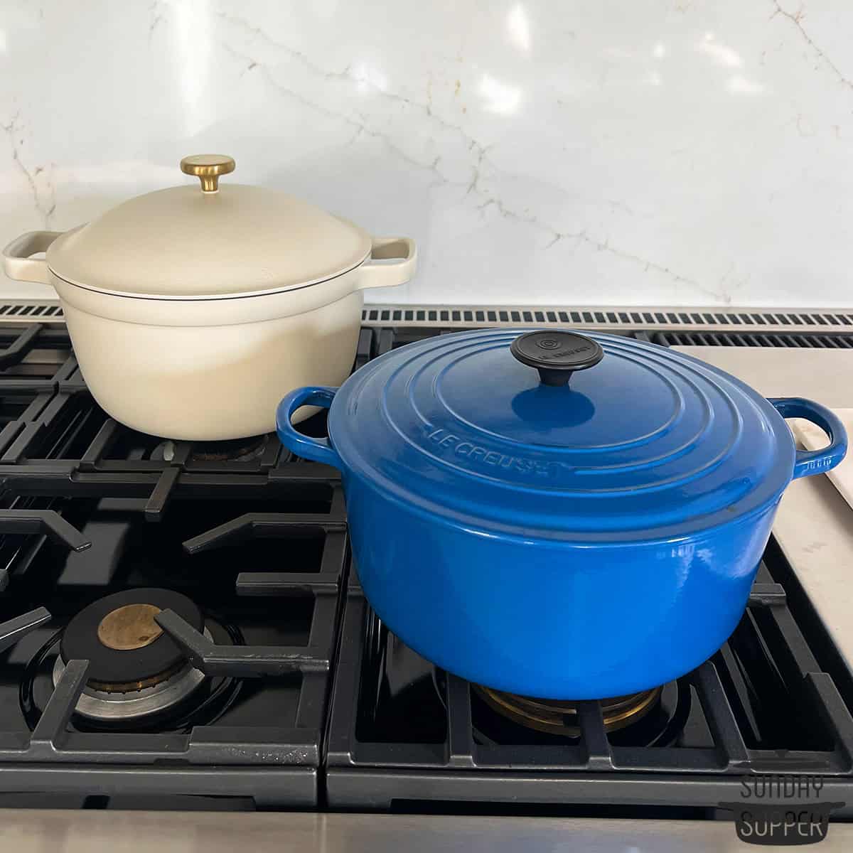 two clean dutch ovens on a stovetop