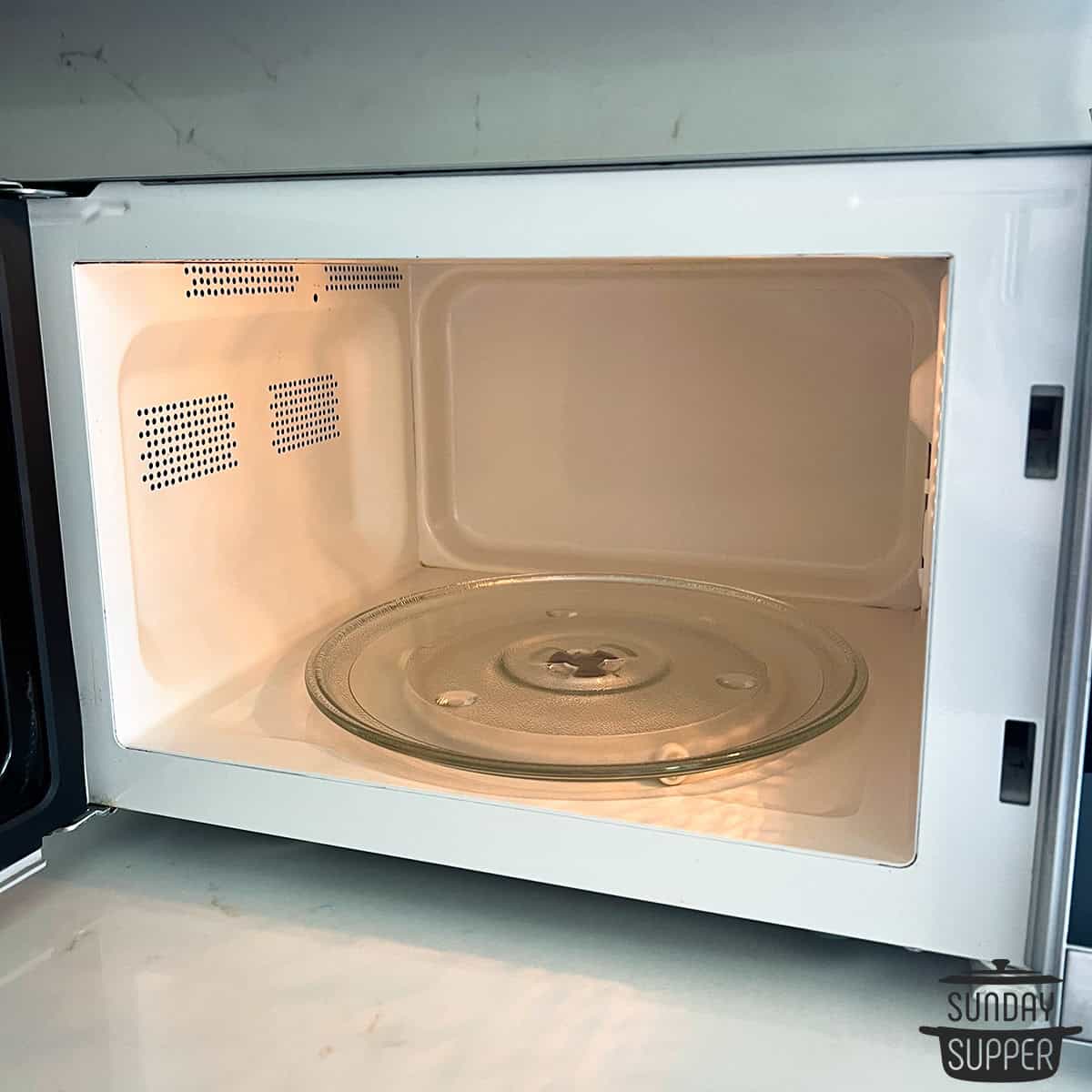 a clean microwave oven open to show interior