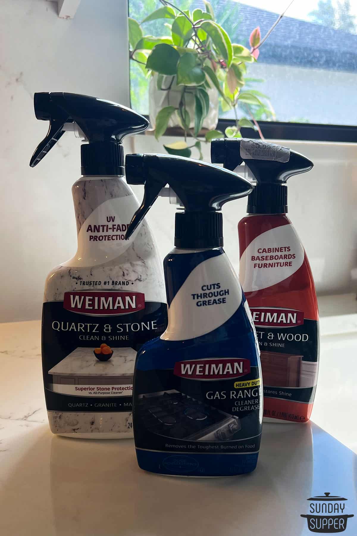 three bottles of weiman brand cleaners