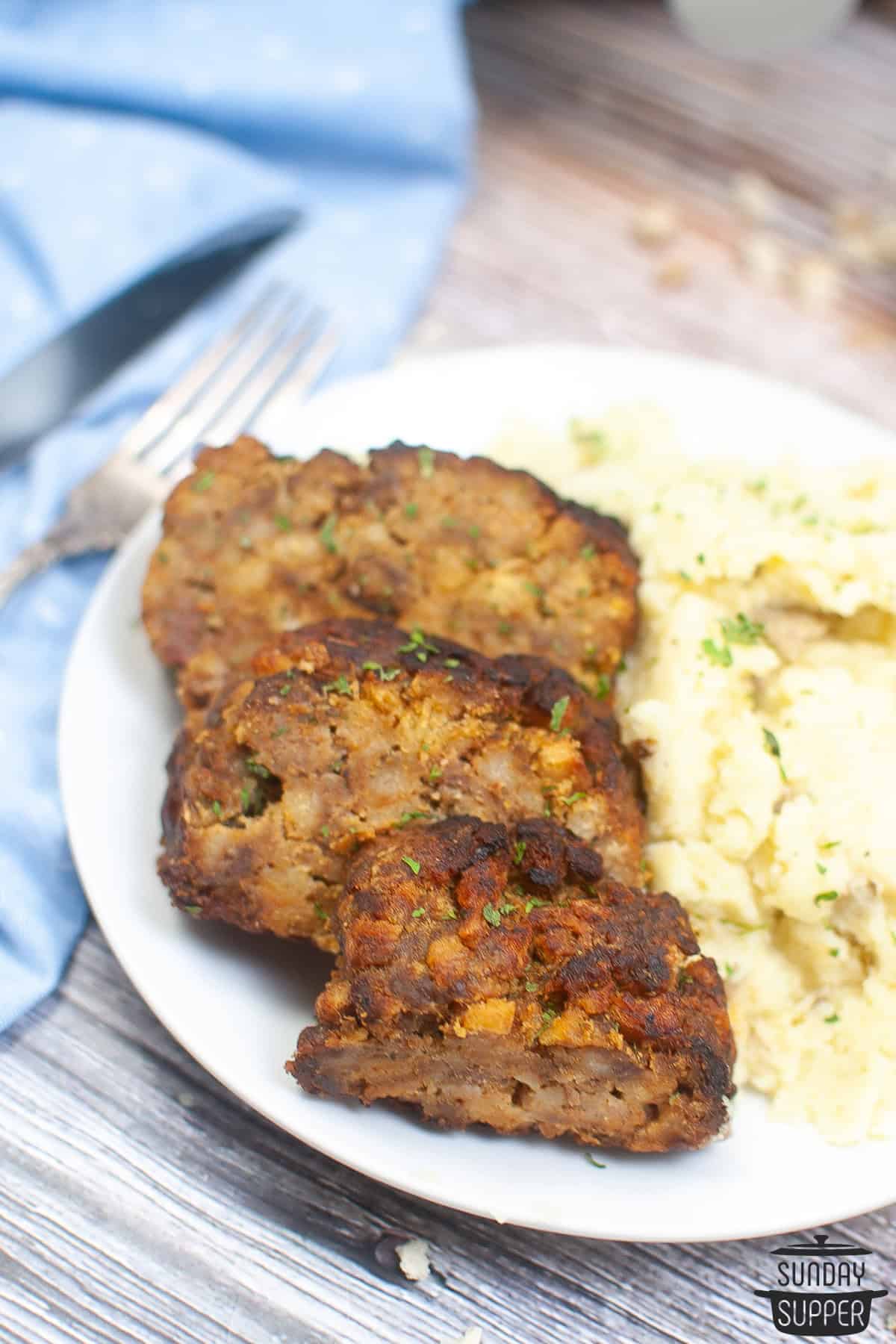 cooked meatloaf on a plate with potatoes