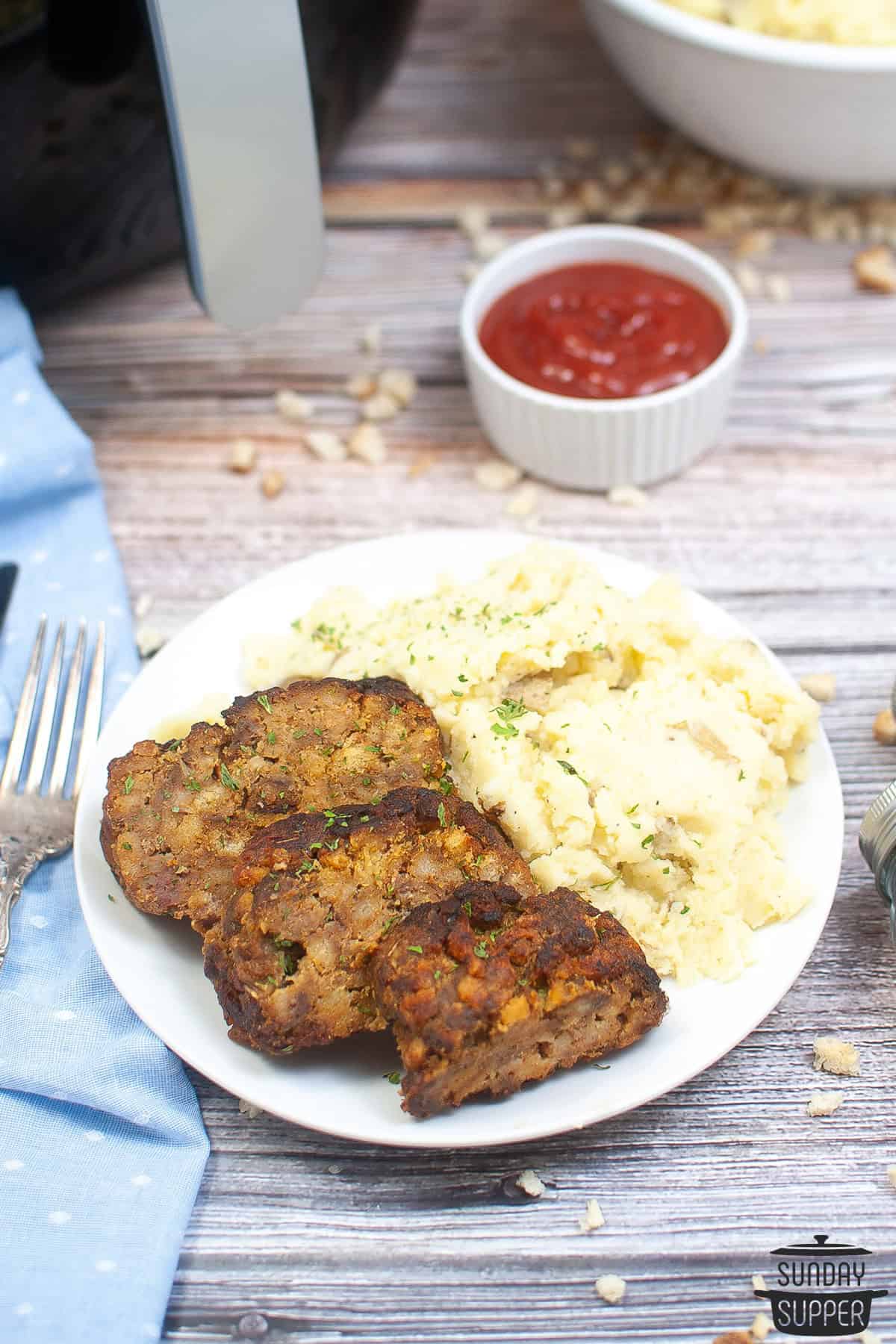 a plate of meatloaf with mashed potatoes