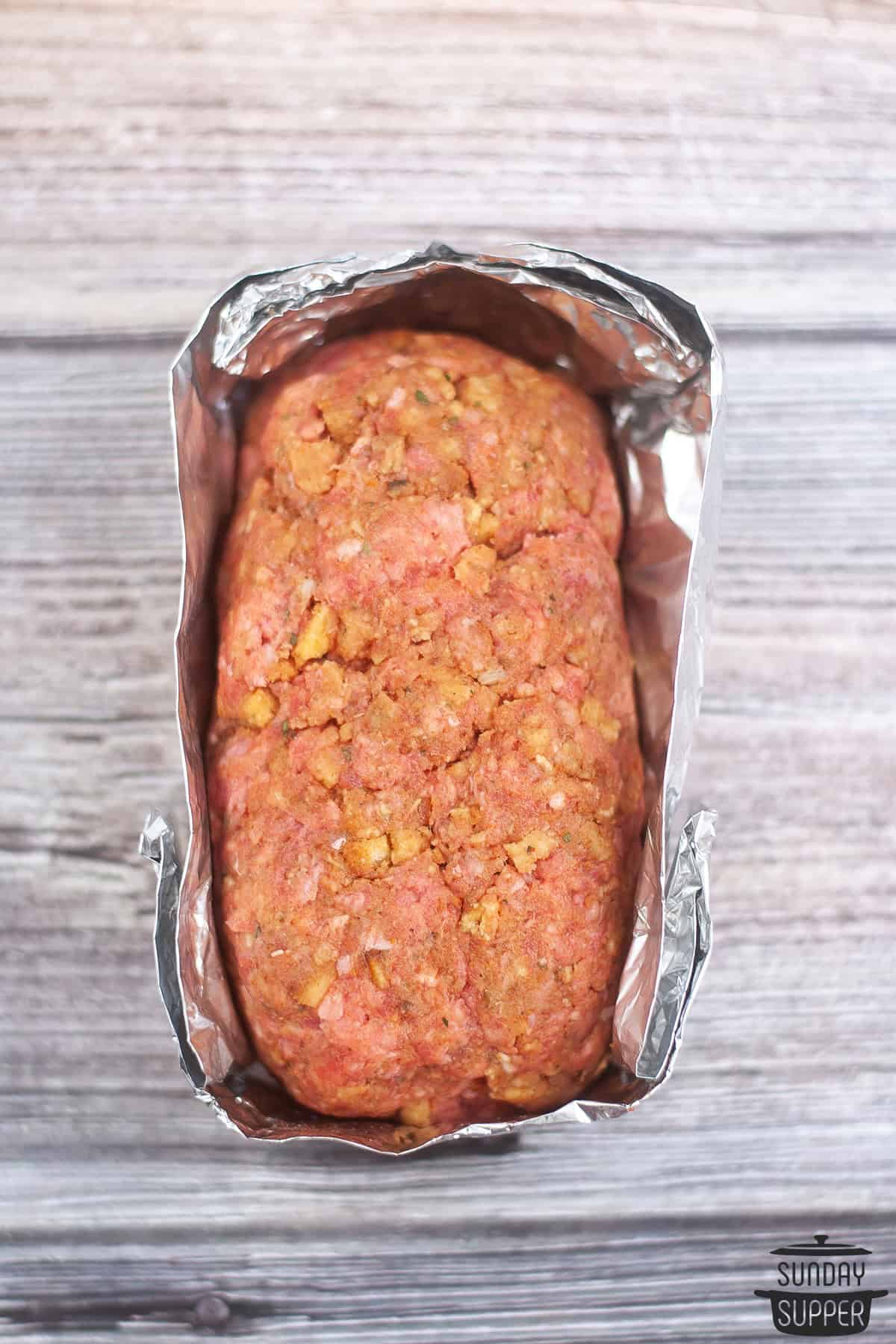 foil folded around an uncooked meatloaf