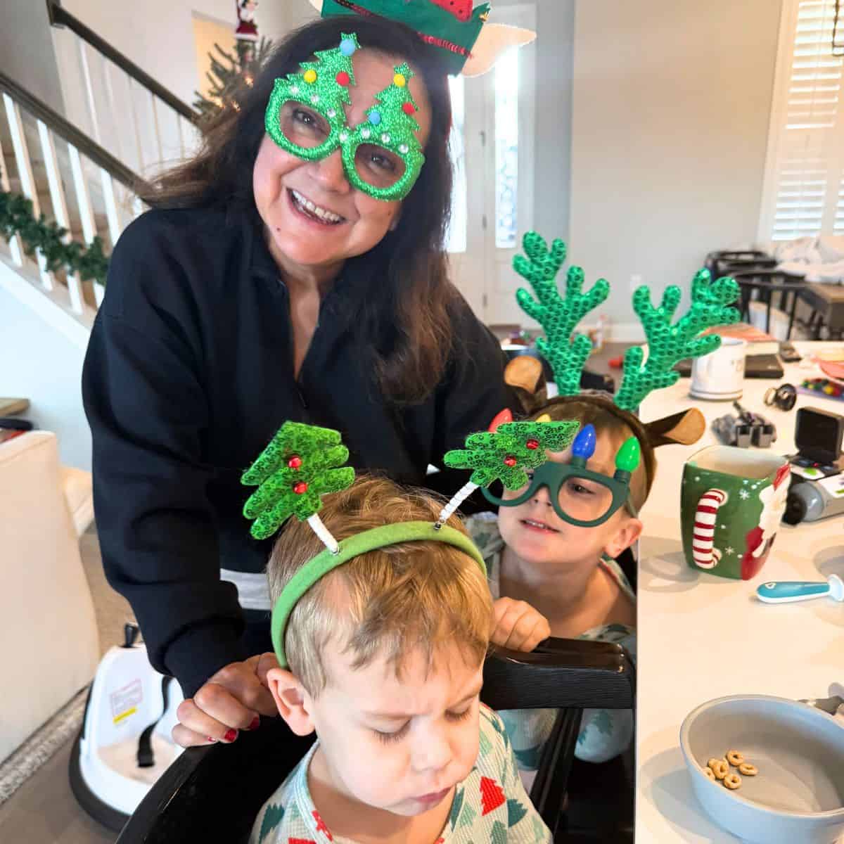 isabel rory and aiden wearing christmas glasses and bobbleheads