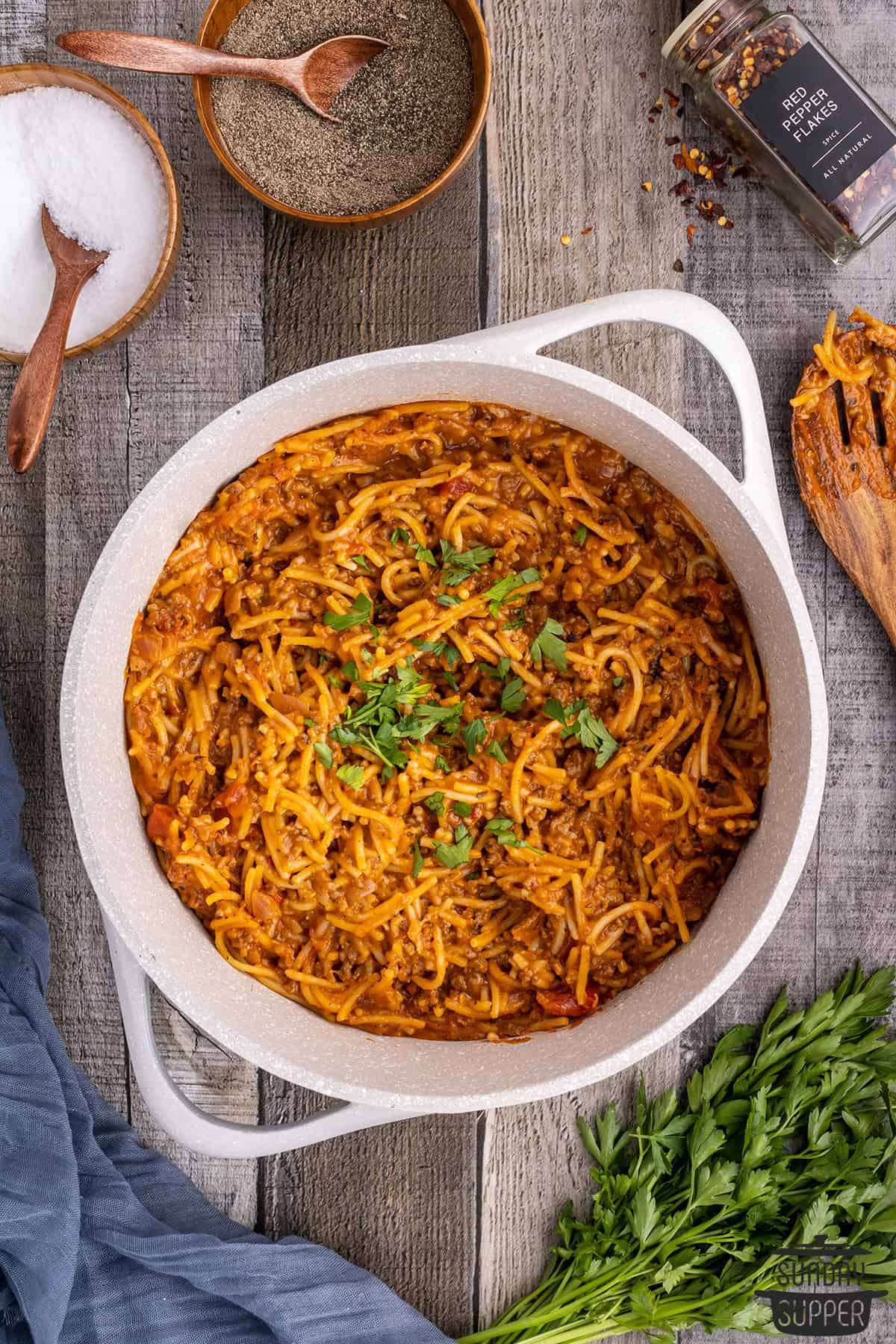 a pot of one pot spaghetti with herb garnish