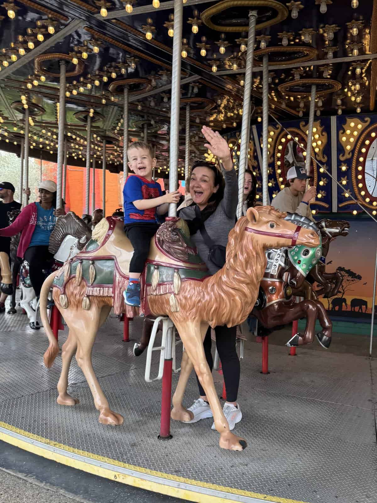 aiden riding on the carousel with isabel