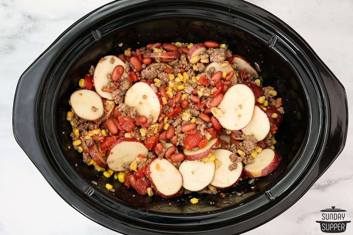 all of the ingredients for the casserole placed in the slow cooker and mixed