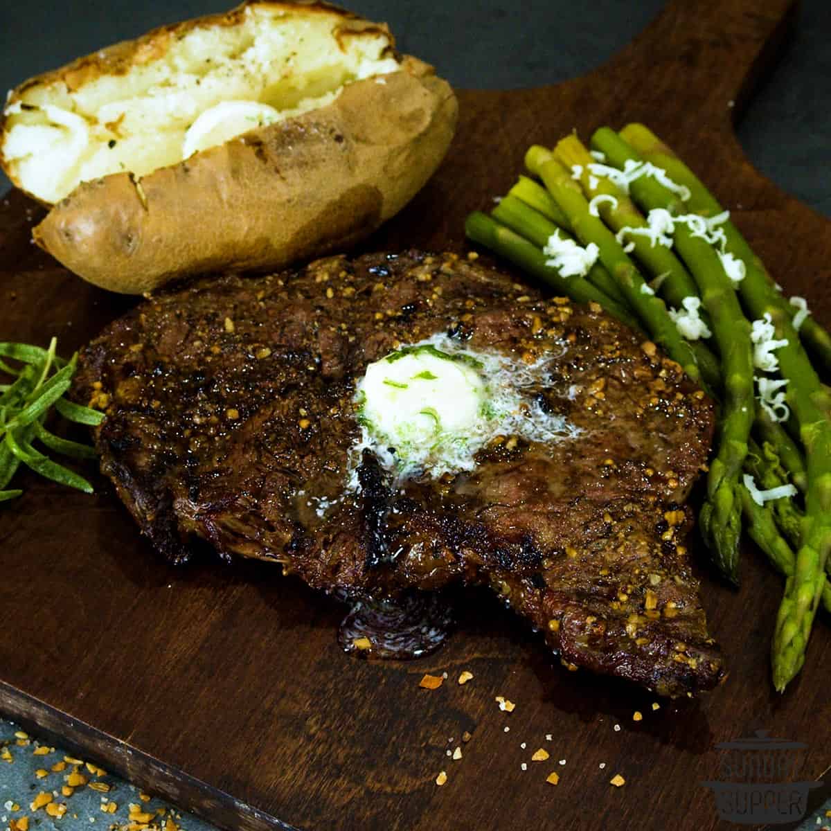 a grilled ribeye steak on a cutting board