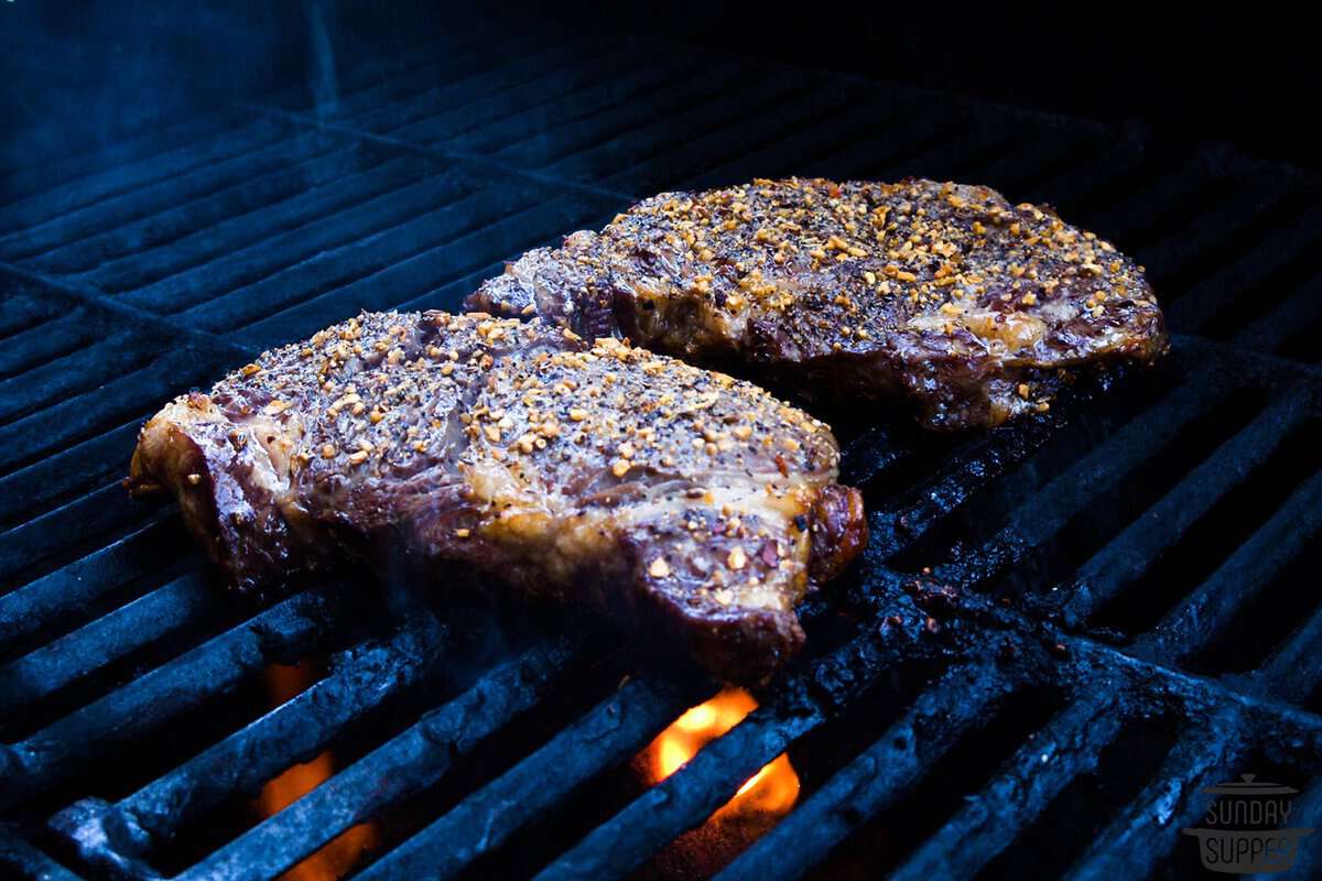 two steaks on a grill