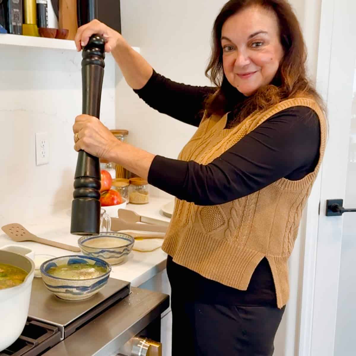 Isabel with a pepper grinder making Italian wedding soup