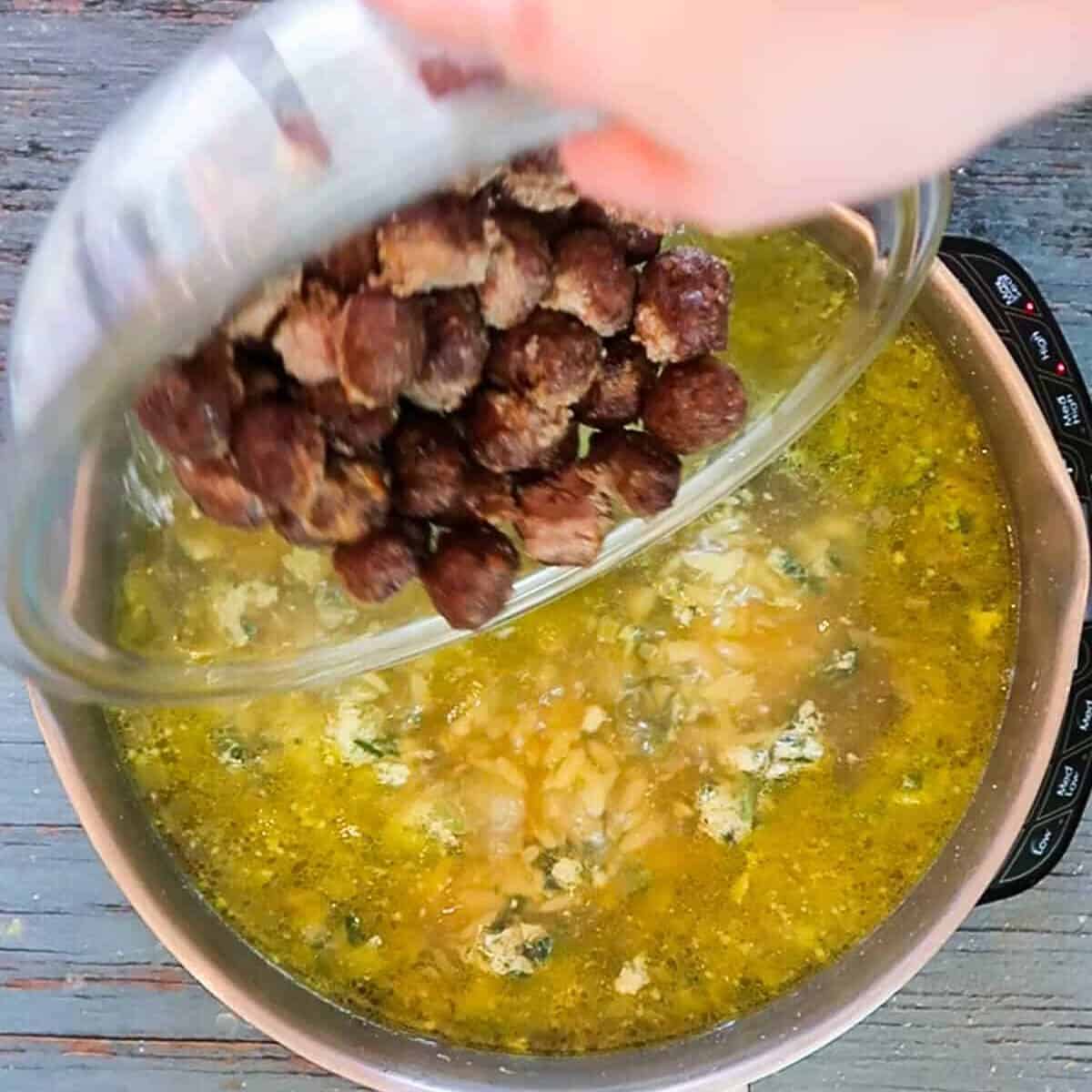 Adding meatballs to Italian wedding soup