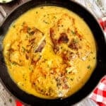 pork chops in onion gravy in a skillet