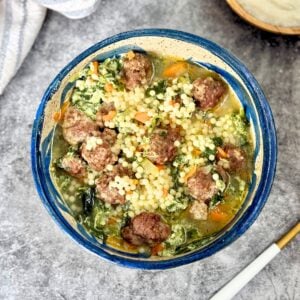 Italian wedding soup in a blue bowl