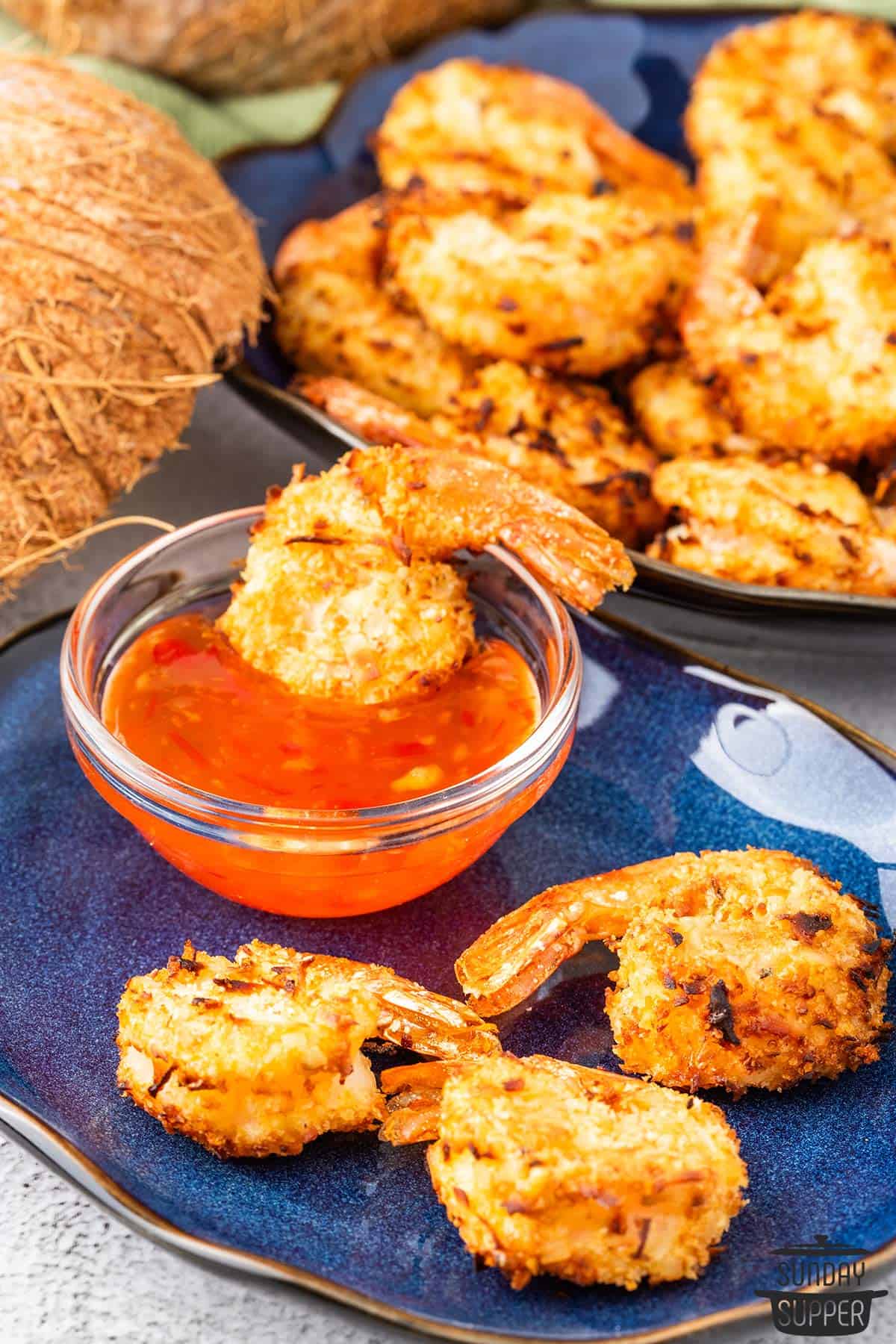 air fryer shrimp on a plate with dipping sauce