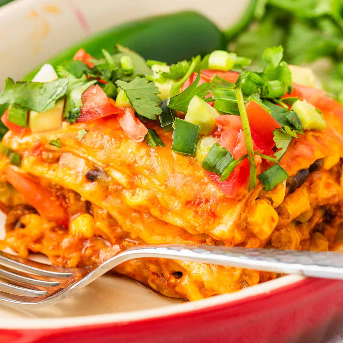 a closeup of the layers of beef enchilada casserole