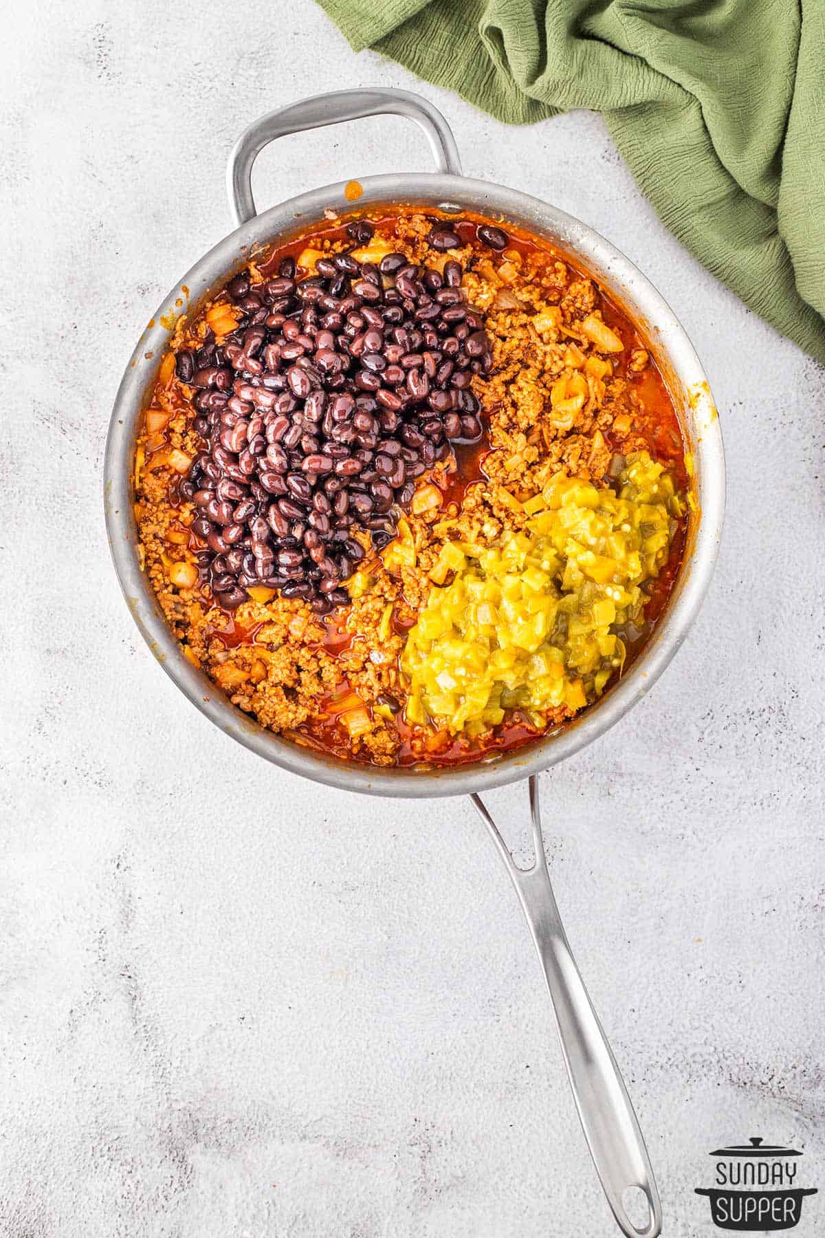 chiles and beans added to the beef mixture