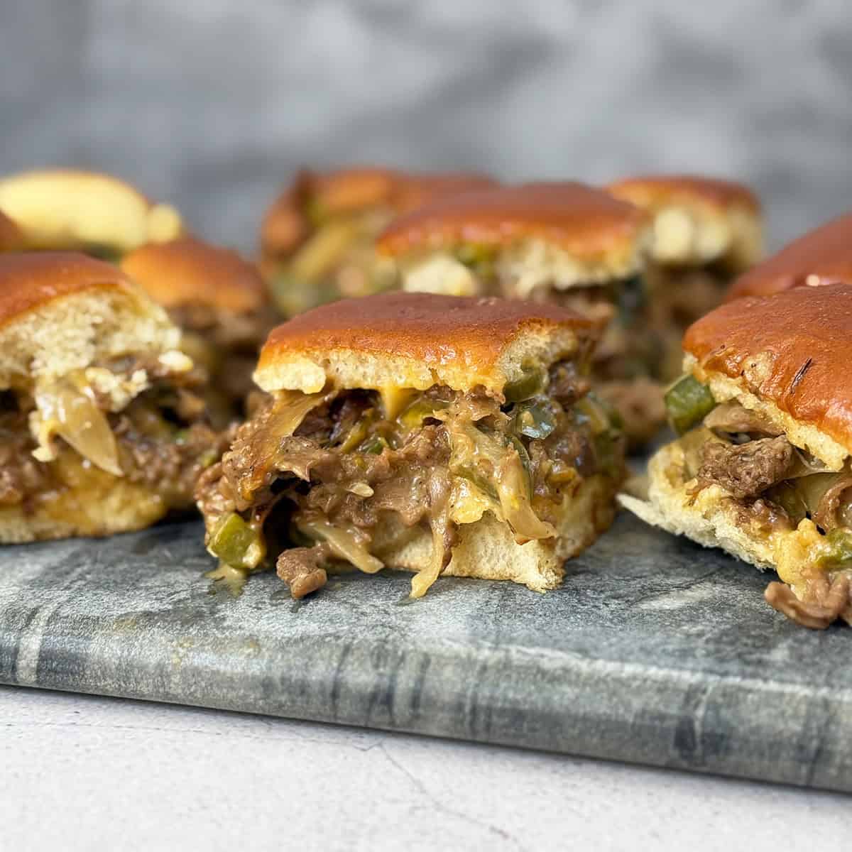 Cheesesteak sliders on a serving board