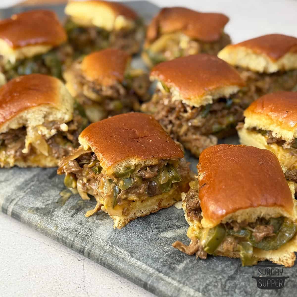 Philly cheesesteak sliders recipe on a serving board