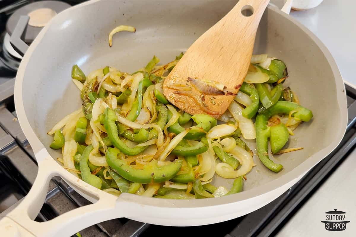 browned peppers and onions in the pan